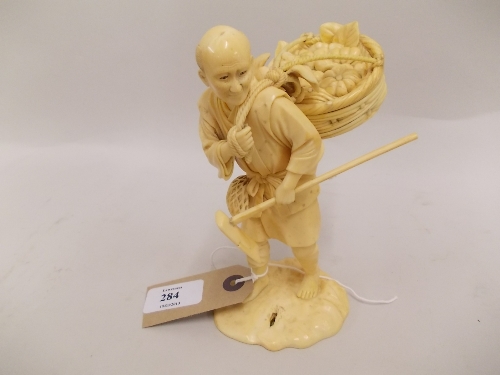 19th Century Japanese carved ivory figure of an agricultural worker carrying a basket of fruit and