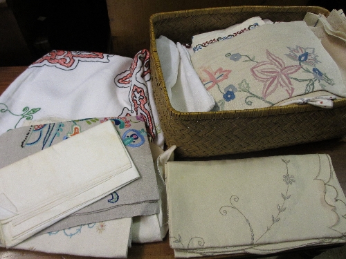 Basket containing quantity of various embroidered table linen