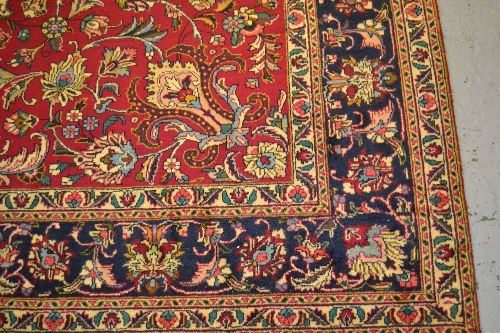 Kashan carpet (signed), having red ground, 3.42m x 2.5m