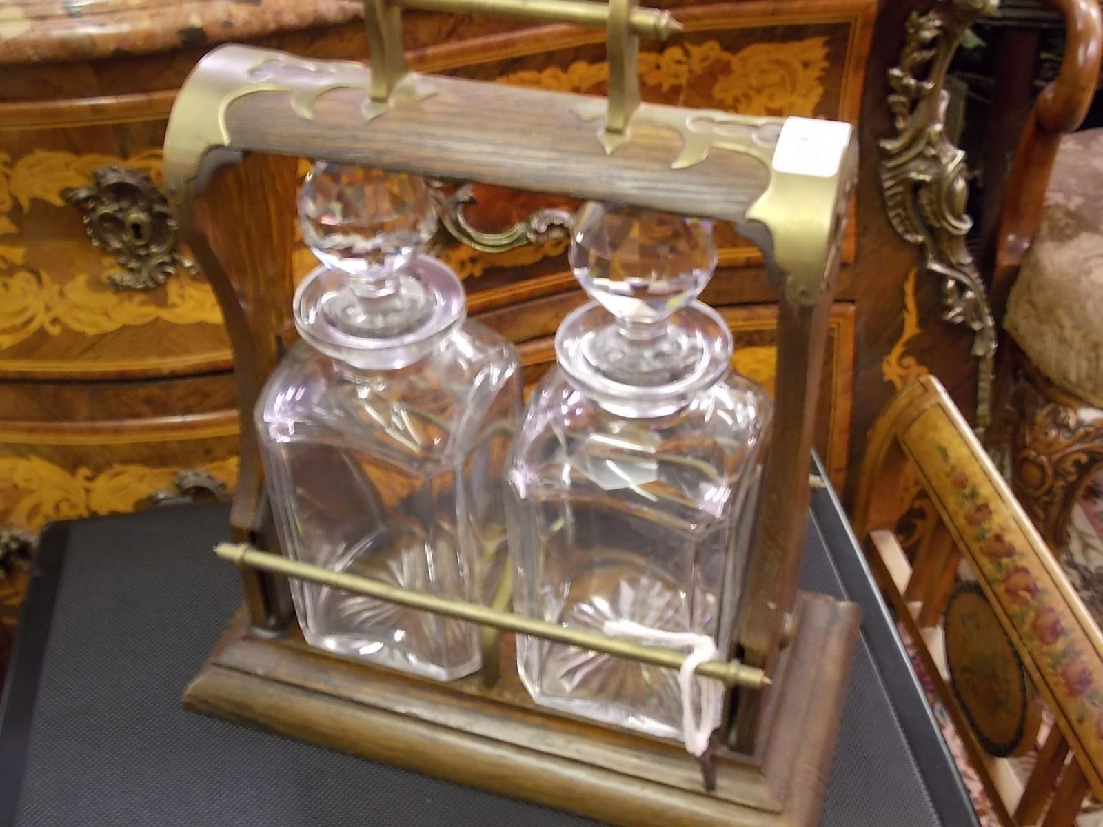 Oak brass mounted two bottle tantalus with bar locking system, Bramah lock and cut glass decanters