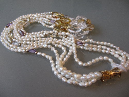 Four strand pearl necklace with gold clasp