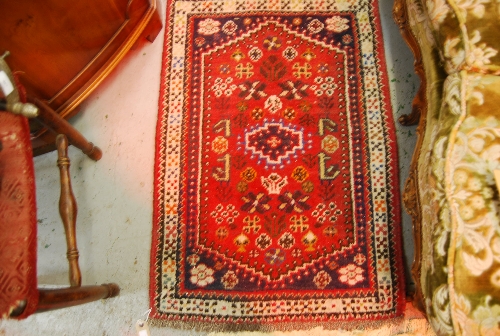 Two small Iranian rugs on wine ground