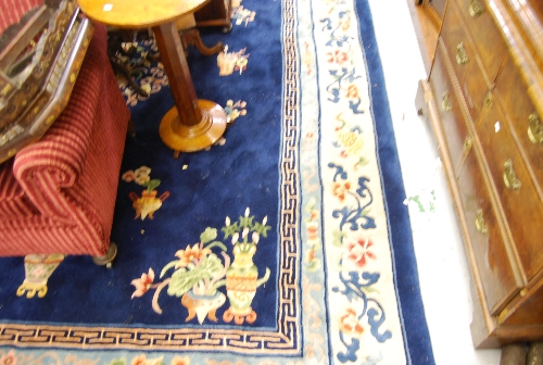 Chinese carpet with medallion and floral design on blue ground