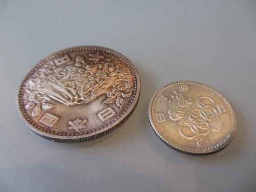 1964 Tokyo Olympic coin together with a similar smaller coin