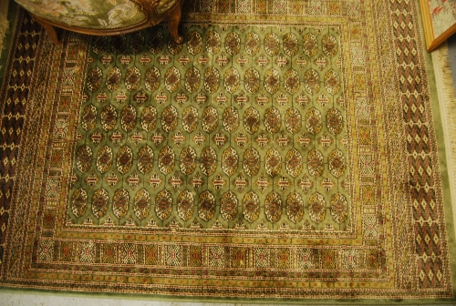 Bokara style rug having green ground, 1.7m x 1.25m