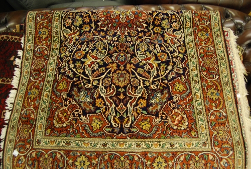 Small Indo Persian rug with medallion and all-over floral design on a midnight blue ground with