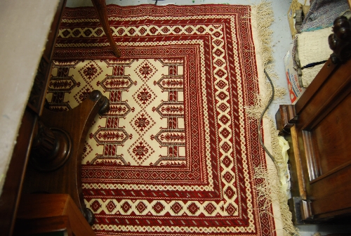 Indo Persian Turkoman style rug with repeating designs on an ivory ground with multiple border