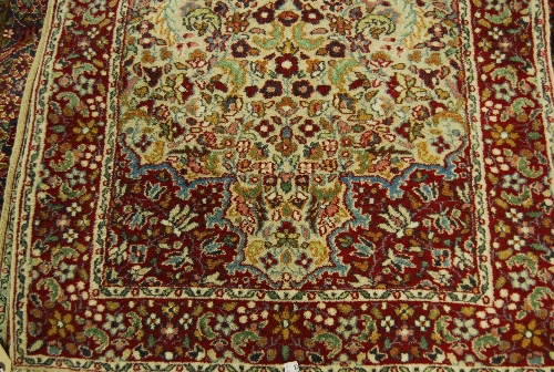 Small Indo Persian rug with medallion and floral design on a grey ground