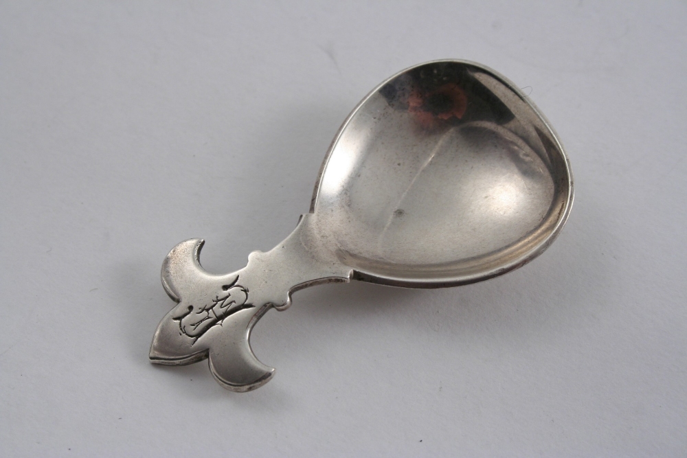 A MODERN SMALL CADDY SPOON with a fleur-de-lys terminal, initialled "LWE", maker`s mark "WJD",