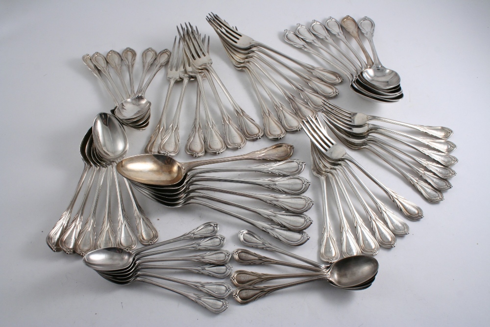 A VICTORIAN PART CANTEEN OF LILY PATTERN FLATWARE: Twelve table spoons, twelve table forks, twelve