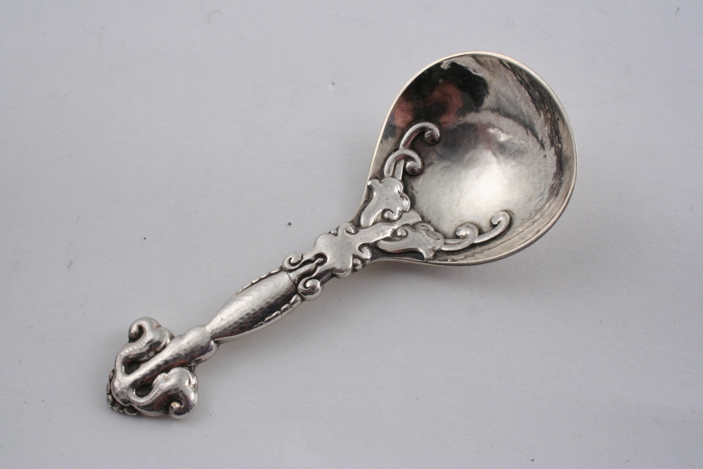 A HANDMADE SCANDINAVIAN CADDY SPOON with a hammered finish, maker`s mark "DP", early 20th century