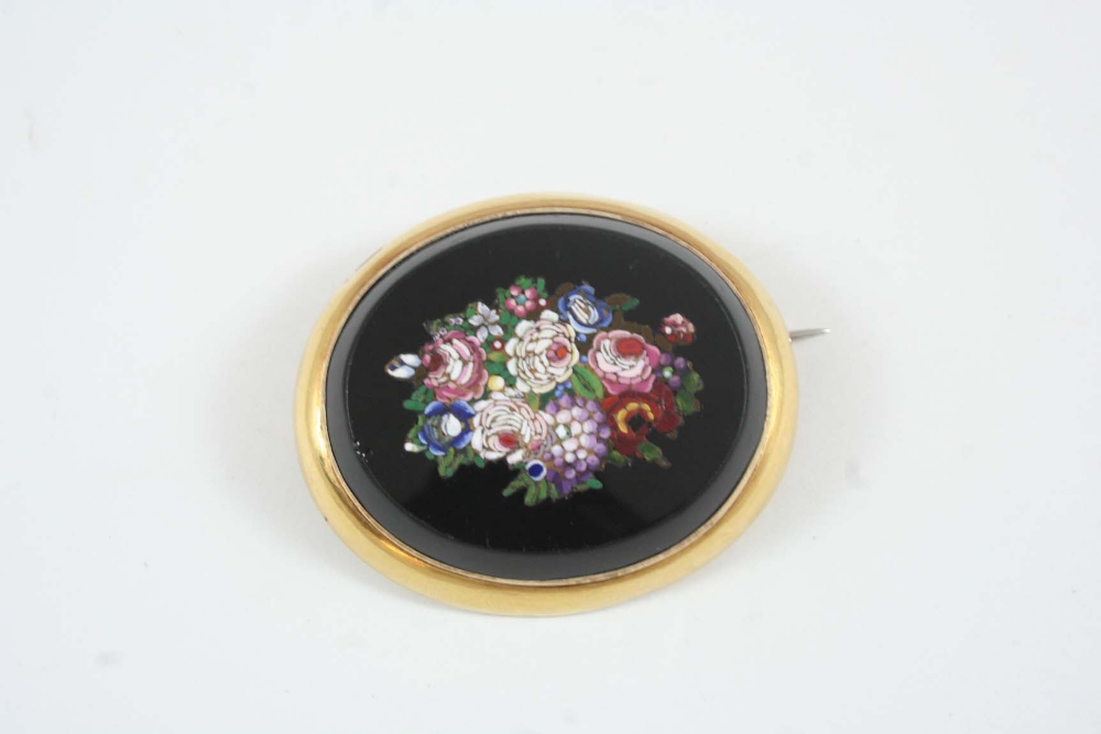 A MICROMOSAIC BROOCH the oval brooch with micromosaic detail of floral coloured decoration, within a
