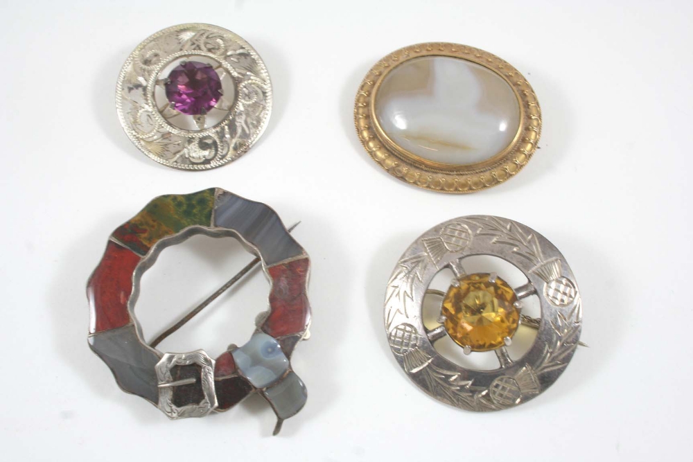 A SCOTTISH HARDSTONE AND SILVER BROOCH circular, 4.5cm. dia., together with three other brooches.