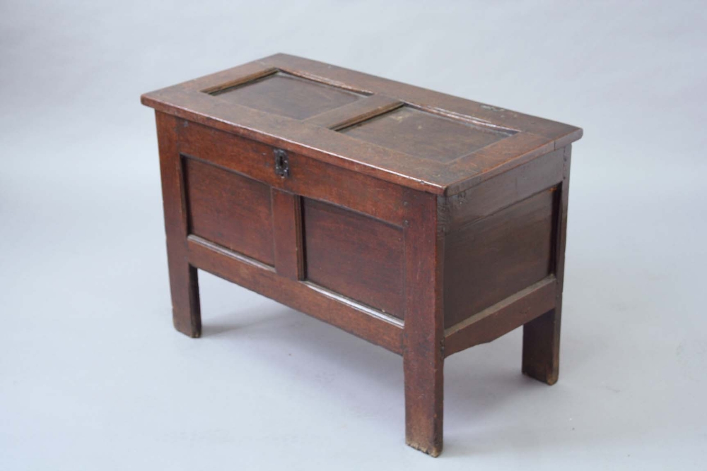 A 17TH CENTURY OAK COFFER with a twin panelled top and front, 36 1/4ins. (92cms.) wide