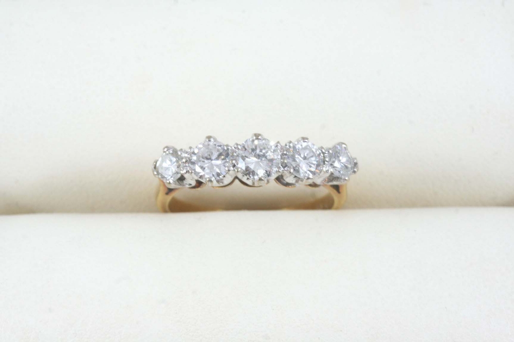 A DIAMOND FIVE STONE RING set with five graduated brilliant-cut diamonds, in gold. Size N.