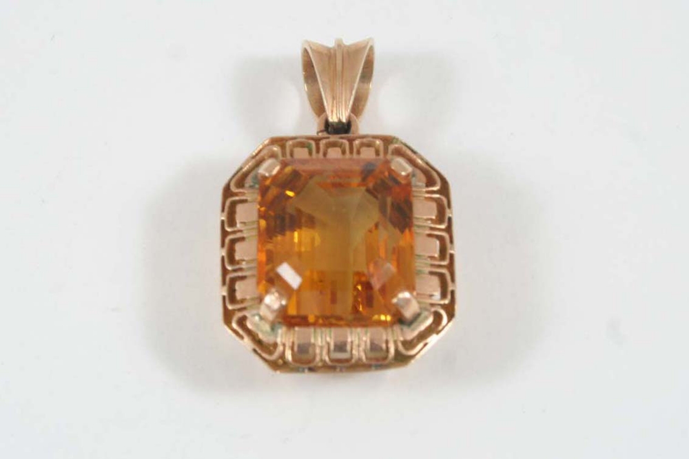 A CITRINE AND GOLD PENDANT the rectangular-shaped citrine is set in 18ct. gold, 2.25cm. long.