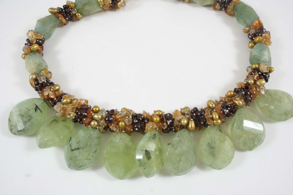 A JADE, CITRINE AND GARNET NECKLACE formed as nine pear-shaped jade drops, with further jade