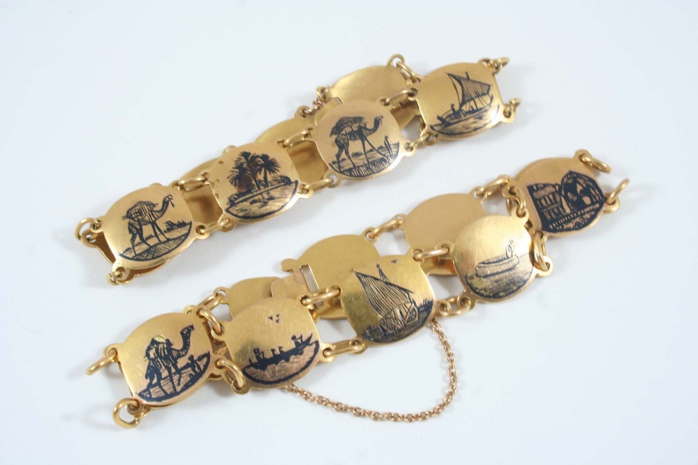 A PAIR OF GOLD PANEL BRACELETS each formed with circular gold panels, each engraved with black