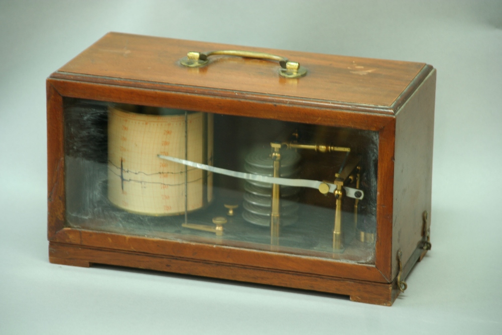 A BRASS BAROGRAPH contained in a part glazed mahogany case, 12 1/4ins. (31cms.) wide