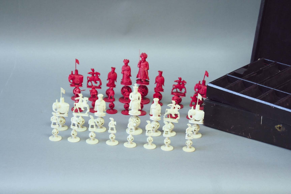 A CHINESE EAST AND WEST RED AND WHITE IVORY PART CHESS SET white Queen missing, each piece on a