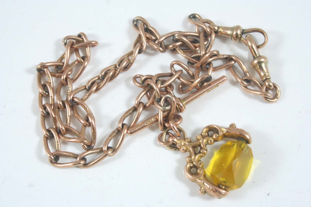 A 9CT. ROSE GOLD WATCH CHAIN suspending a gold `t` bar and a spinning fob, 31 grams.