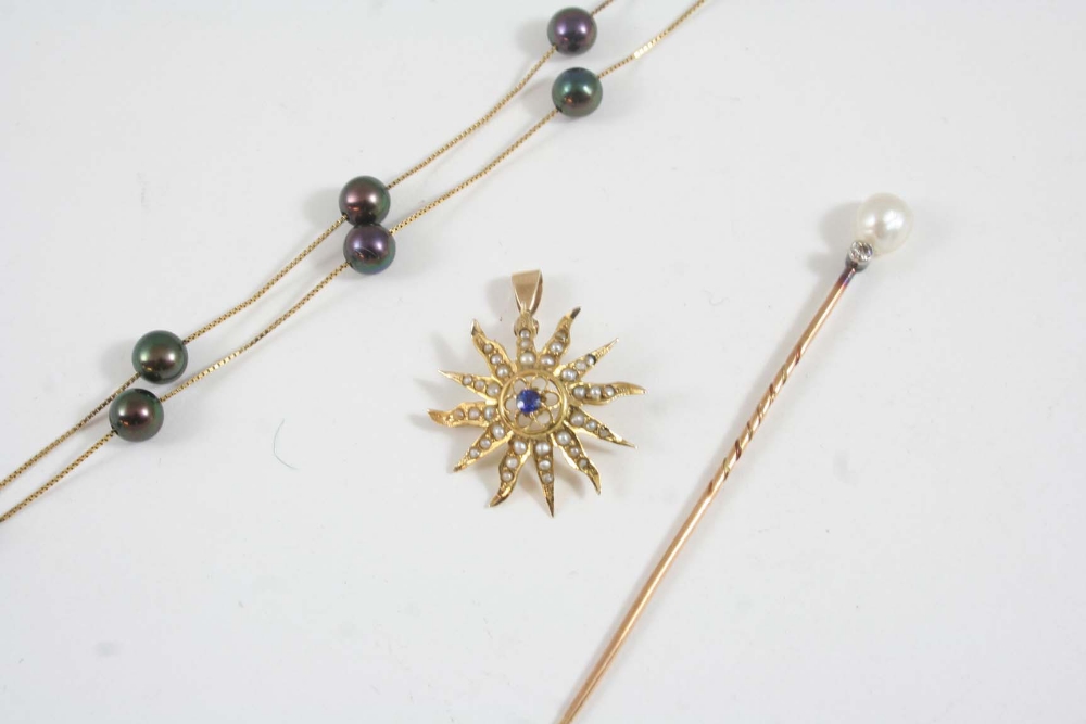 A GOLD STICK PIN set with a small diamond and an untested pearl, together with a sapphire and