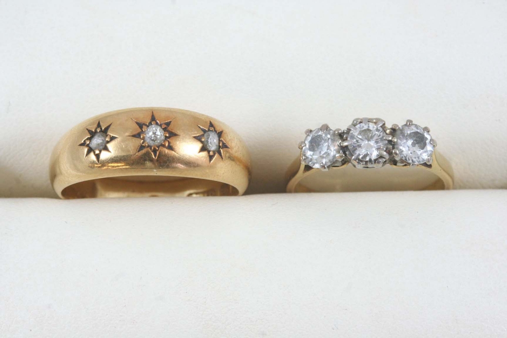 A DIAMOND THREE STONE RING set with three circular-cut diamonds, in 18ct. gold. Size L. Together