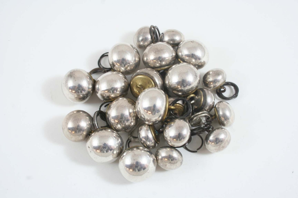 A SET OF ANTIQUE SILVER FRONTED BUTTONS of ball shape, with base metal backs, (22).