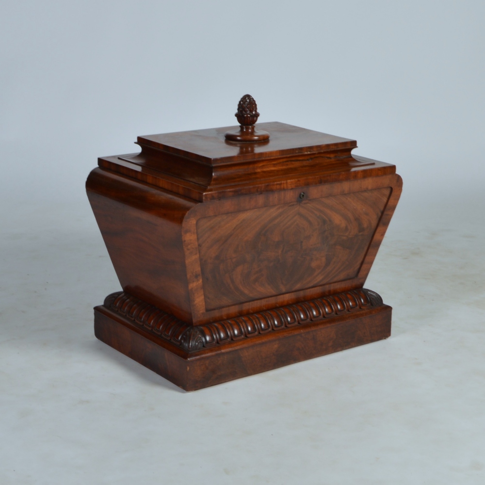 A 19th century mahogany sarcophagus shaped wine cooler, the hinged top centred with an acorn