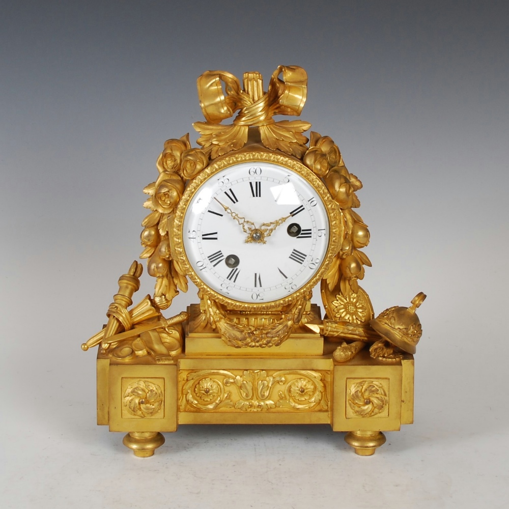 A 19th century Empire ormolu mantle clock, Noel Baltazar, Paris, the 4 1/2" circular convex white