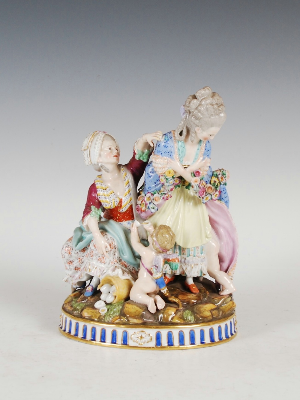 A Meissen porcelain figure group of ladies and cherubs after Acier, modelled with lady and attendant