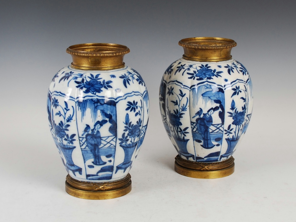 A pair of 19th century gilt metal mounted Delft pottery blue and white Kangxi style jars, the fluted