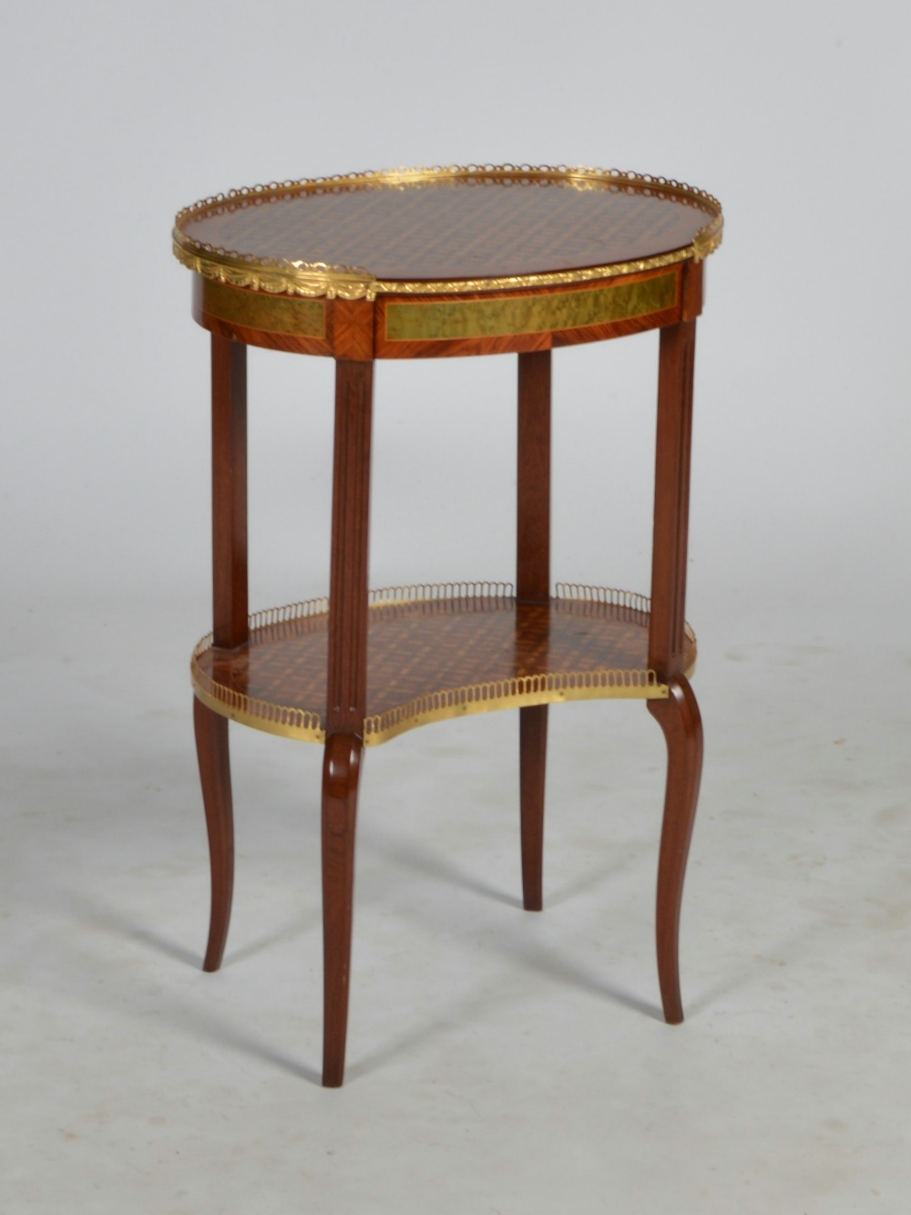 An early 20th century kingwood, specimen wood and gilt metal mounted occasional table, the oval