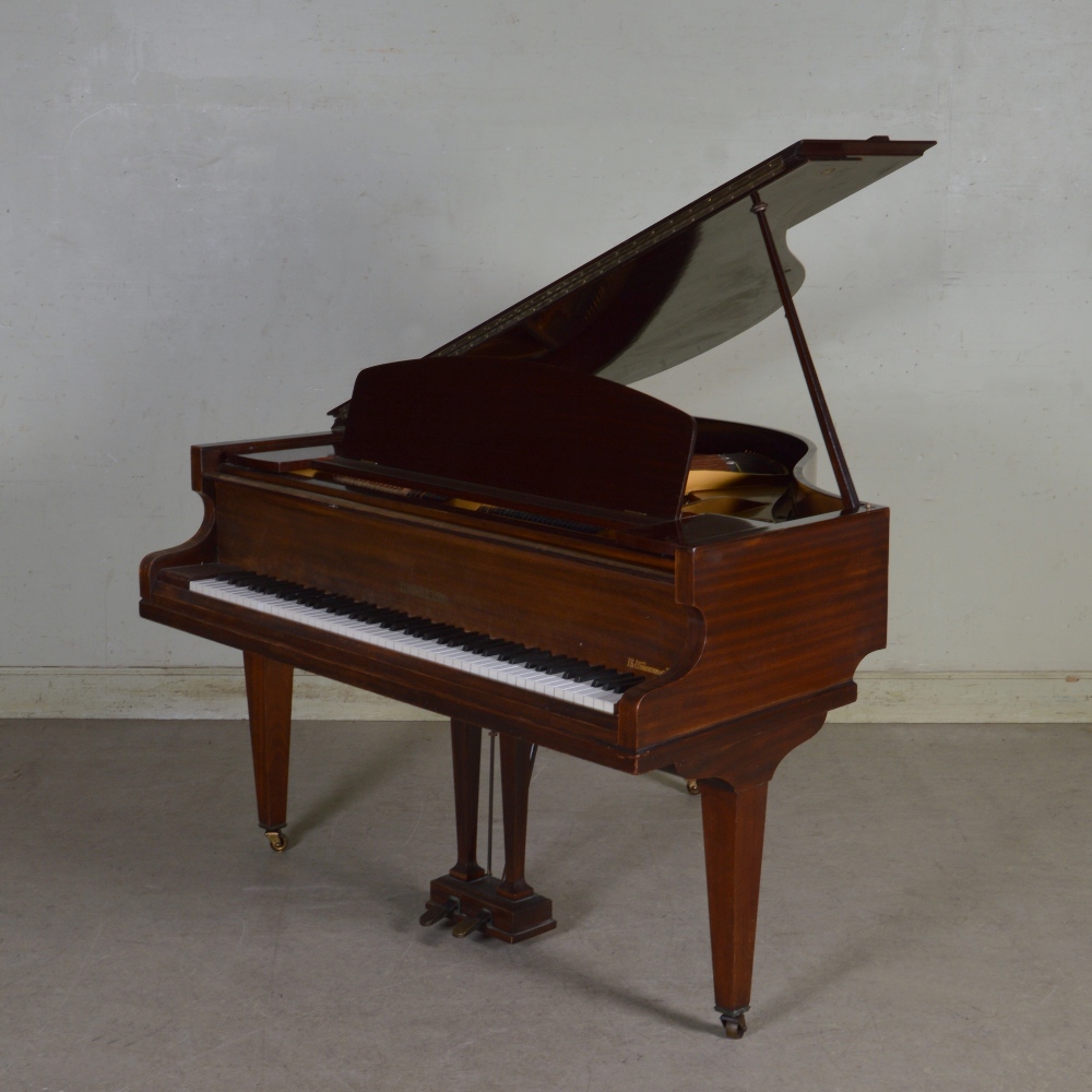 A mahogany cased boudoir grand piano by Challen, on tapered square supports and casters, together