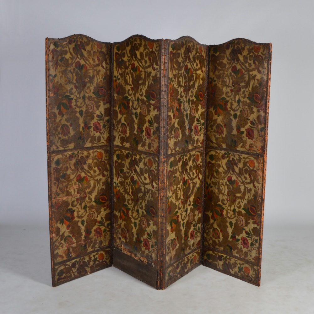 An early 20th century painted leather four fold screen, polychrome decorated with flowers, fruit and