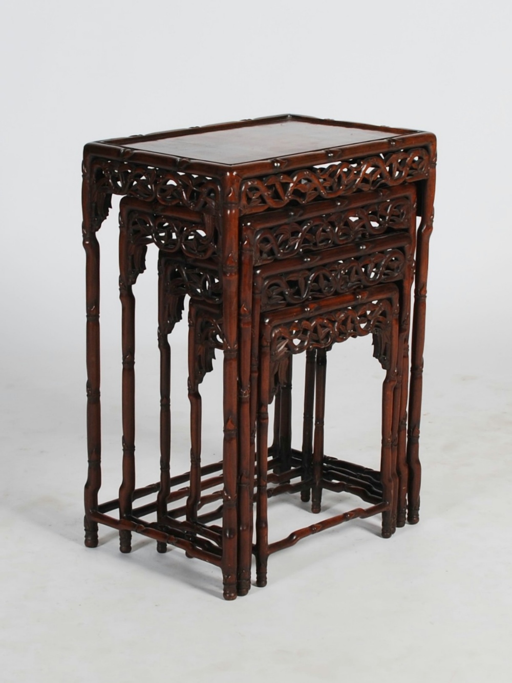 A quartetto of Chinese dark wood occasional tables, late Qing Dynasty, the panelled rectangular tops