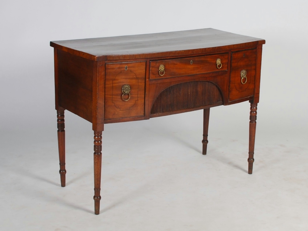 A 19th century mahogany and ebony strung bow front sideboard, the shaped rectangular top above a