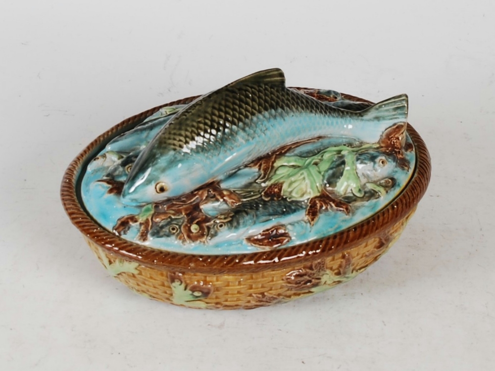 A Victorian majolica sardine dish and cover, the oval-shaped cover moulded with fish, the base