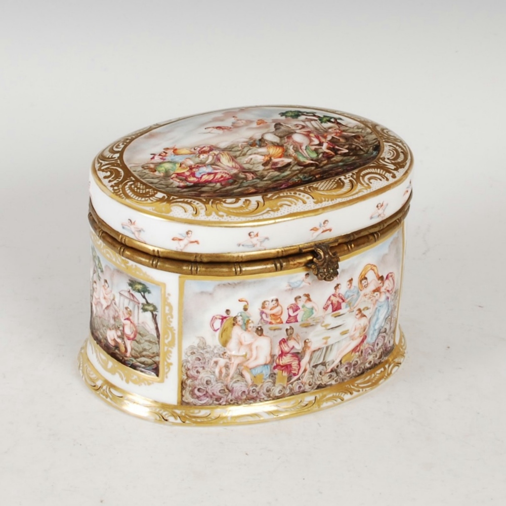 A Naples porcelain gilt metal mounted oval shaped box and cover, moulded with Biblical scenes within