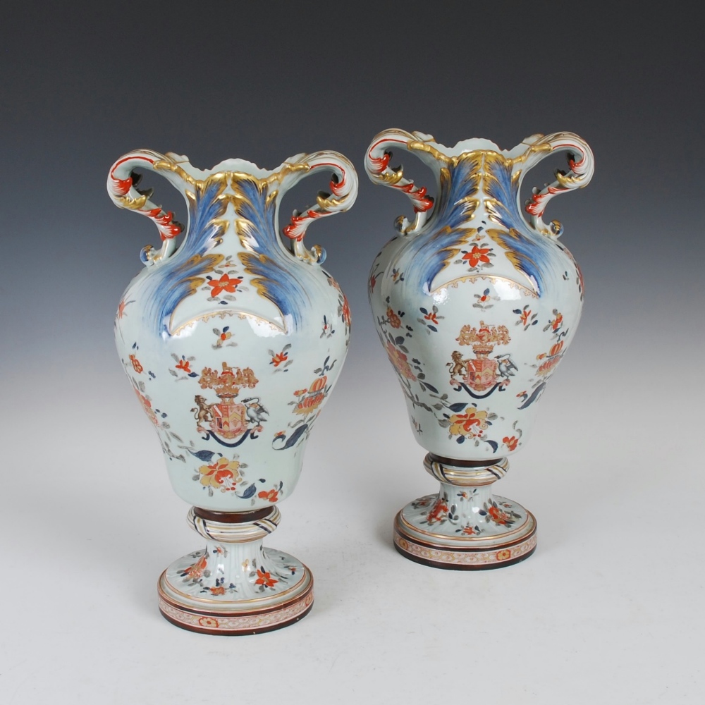 A pair of late 19th century Samson Imari style Armorial twin handled vases, modelled in the Rococo