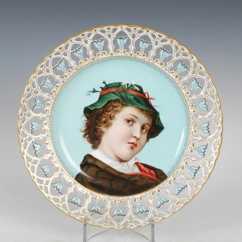 A late 19th century French porcelain hand painted dish, decorated with the bust of a boy on a