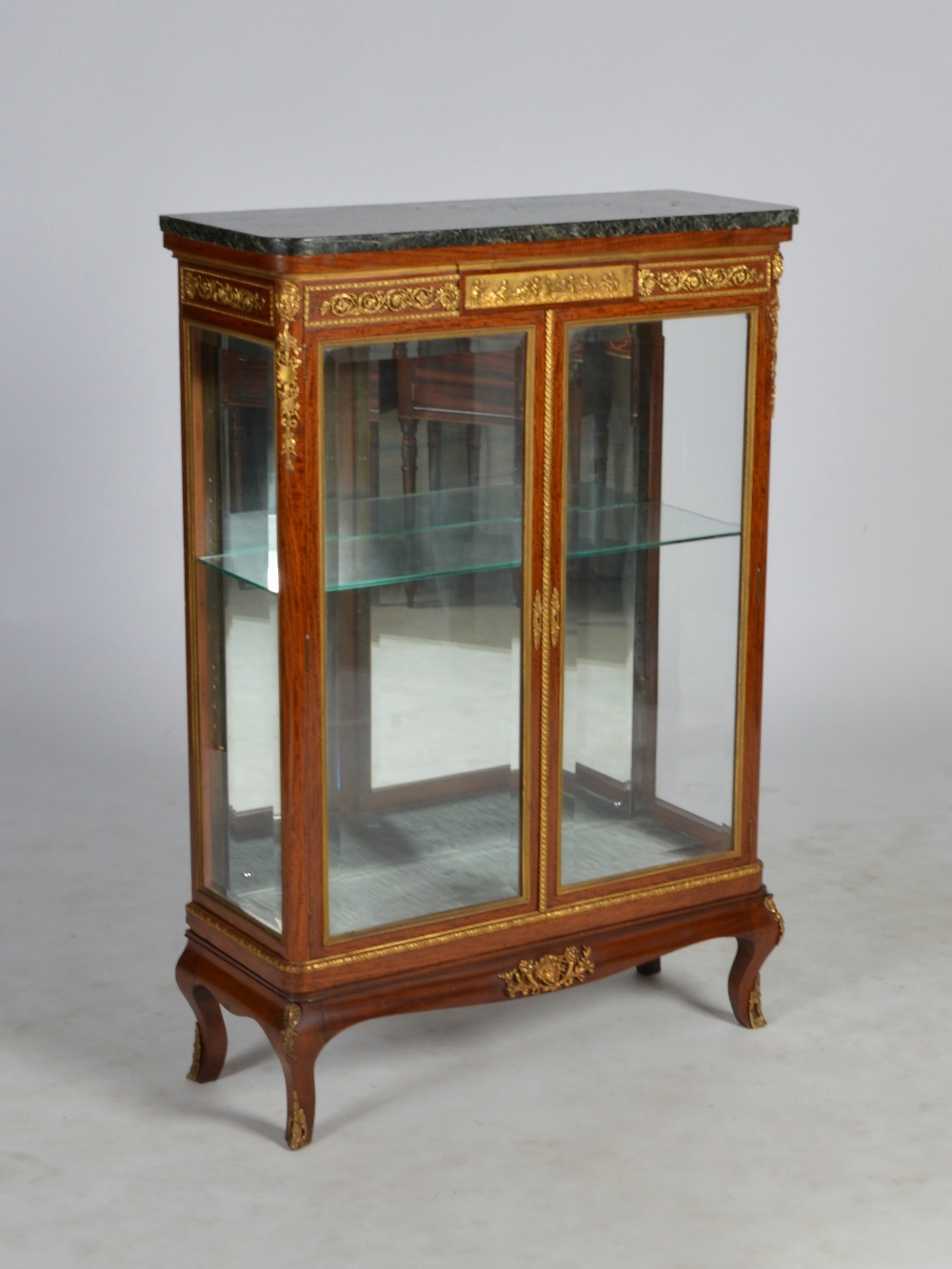 An early 20th century Continental mahogany, gilt metal mounted and marble topped display cabinet,