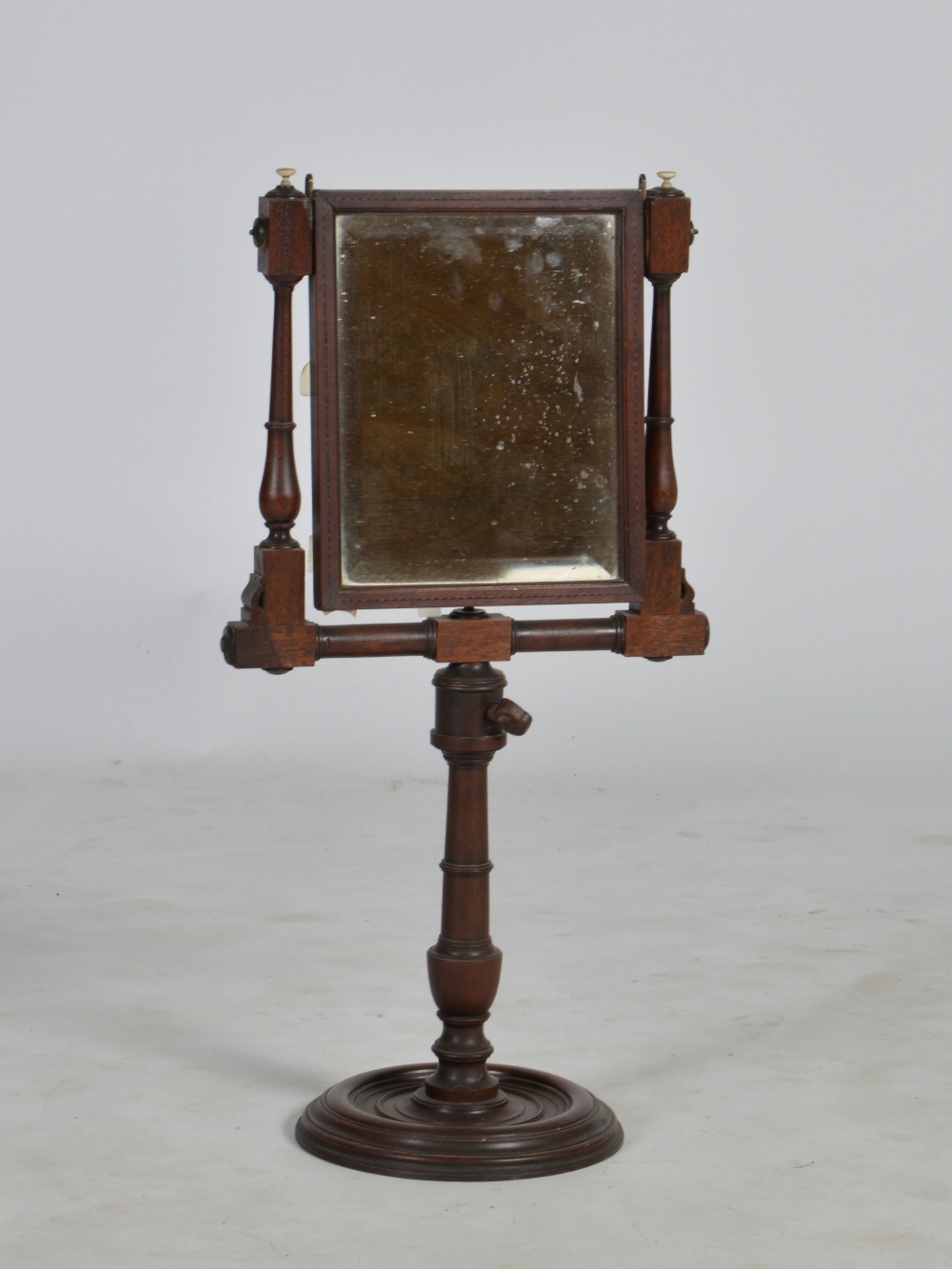 A 19th century mahogany and chequer lined shaving mirror, the hinged rectangular bevelled mirror