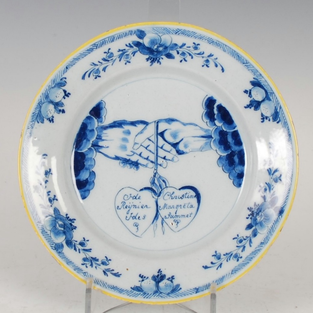 An 18th century Delft marriage plate dated 1784, decorated with hands and double heart betrothal