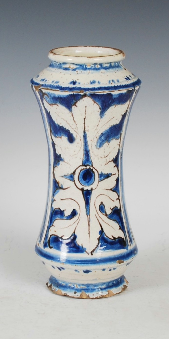 A Continental pottery blue, white and manganese red albarello, decorated with a rectangular panel