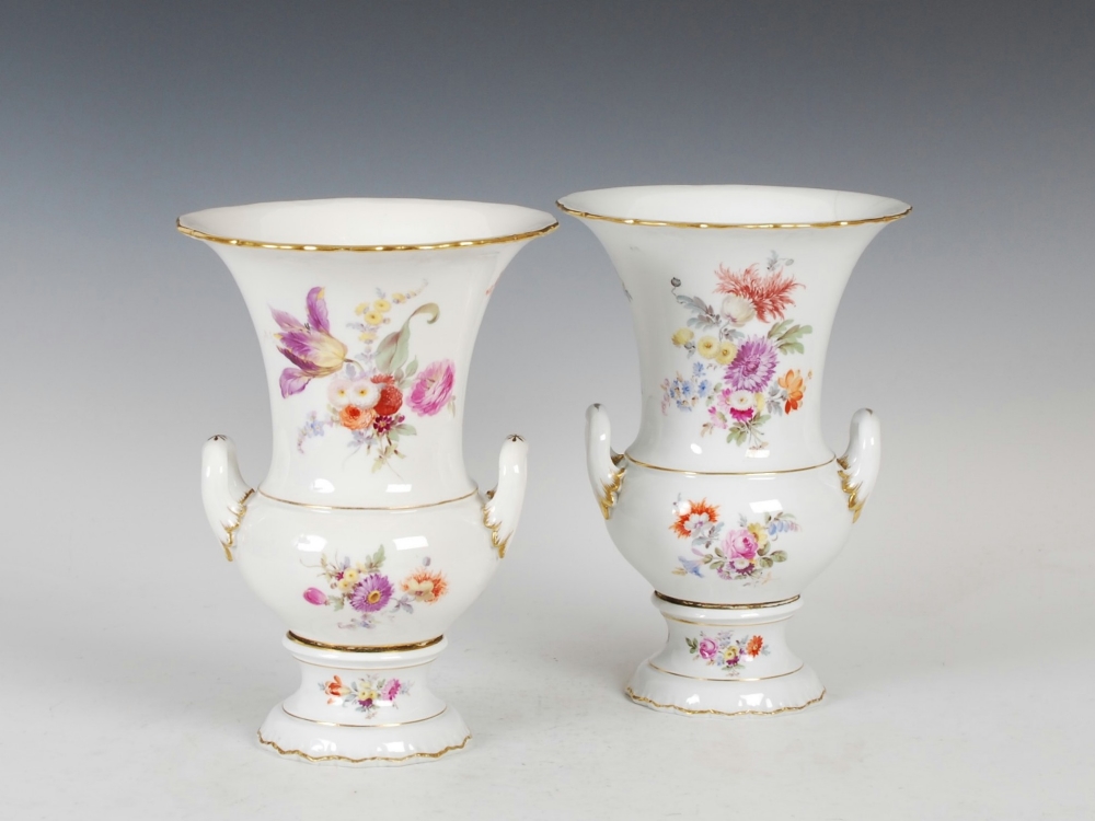 A pair of Meissen porcelain campagna-shaped urns, decorated with deutsche blumen within gilded