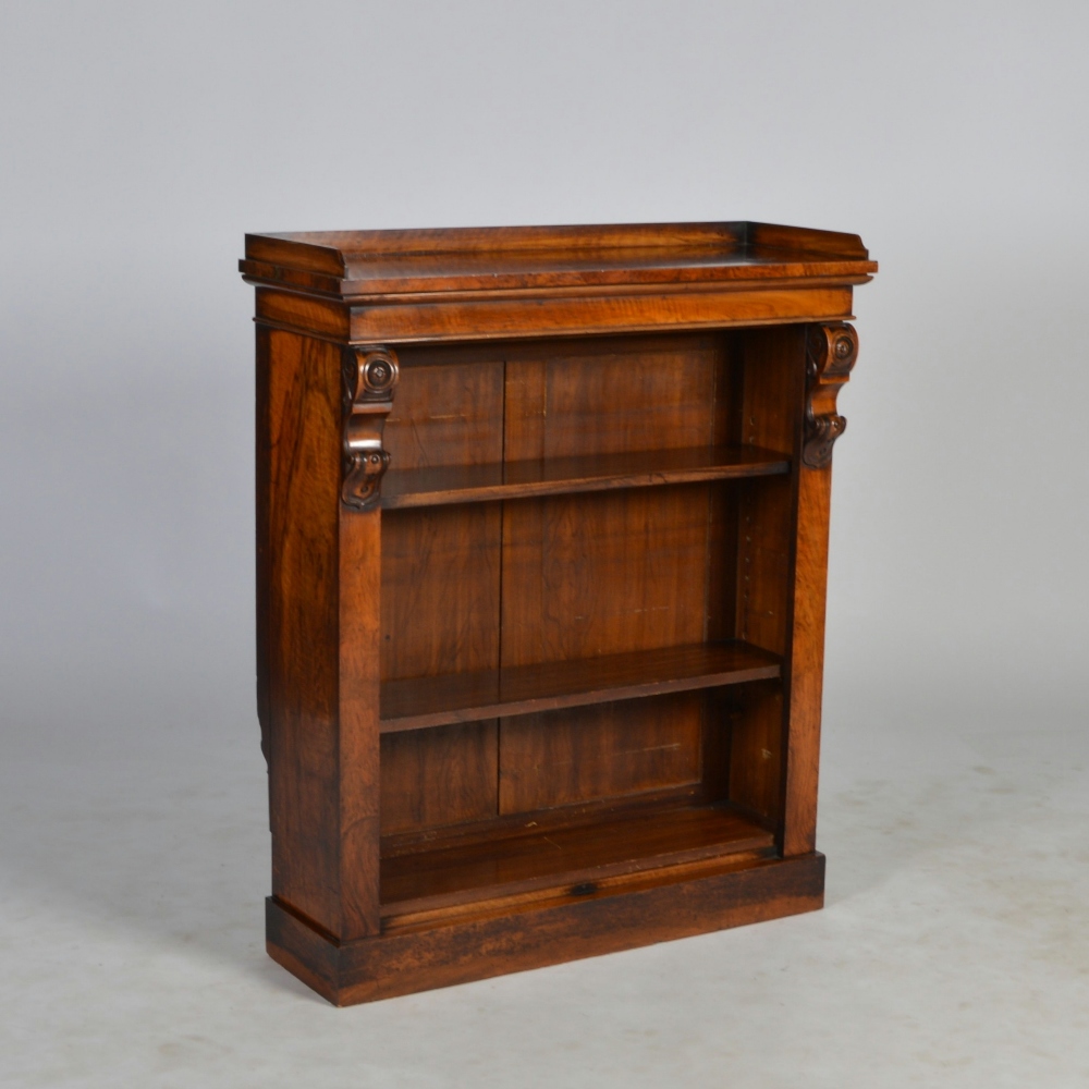 A Victorian walnut bookcase, the rectangular top with three quarter gallery, above a plain frieze