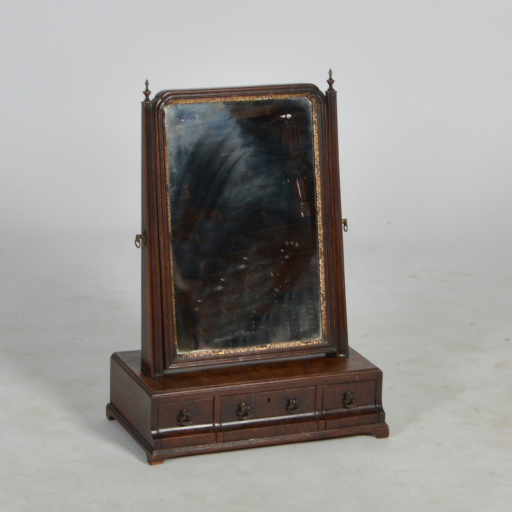 A 19th century walnut and parcel gilt toilet mirror, the rectangular mirror plate supported by