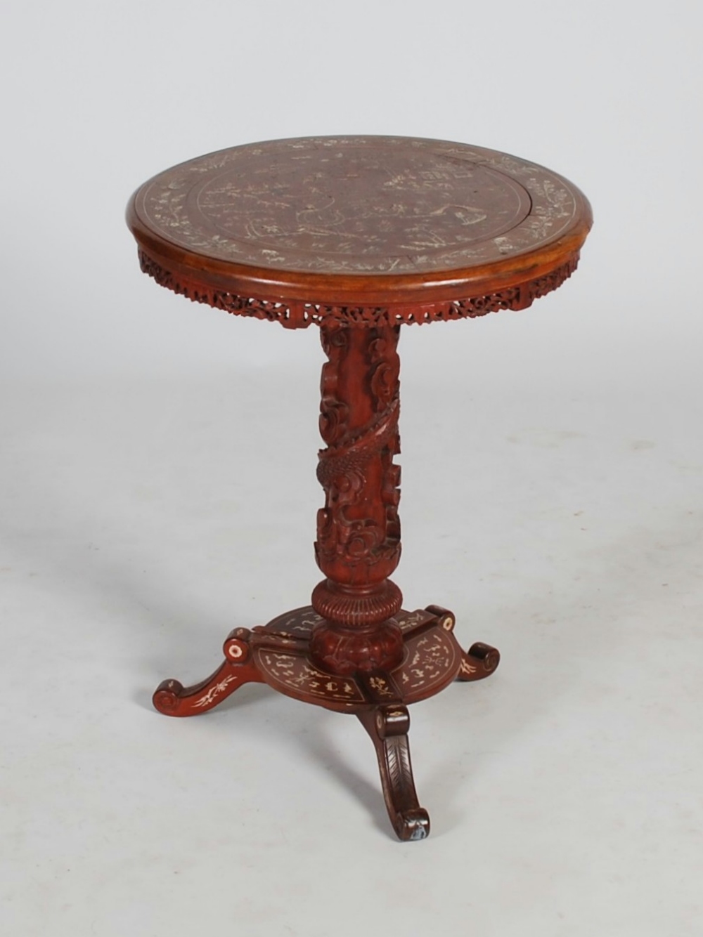 A Chinese bone inlaid stained wood occasional table, late Qing Dynasty, the circular top decorated