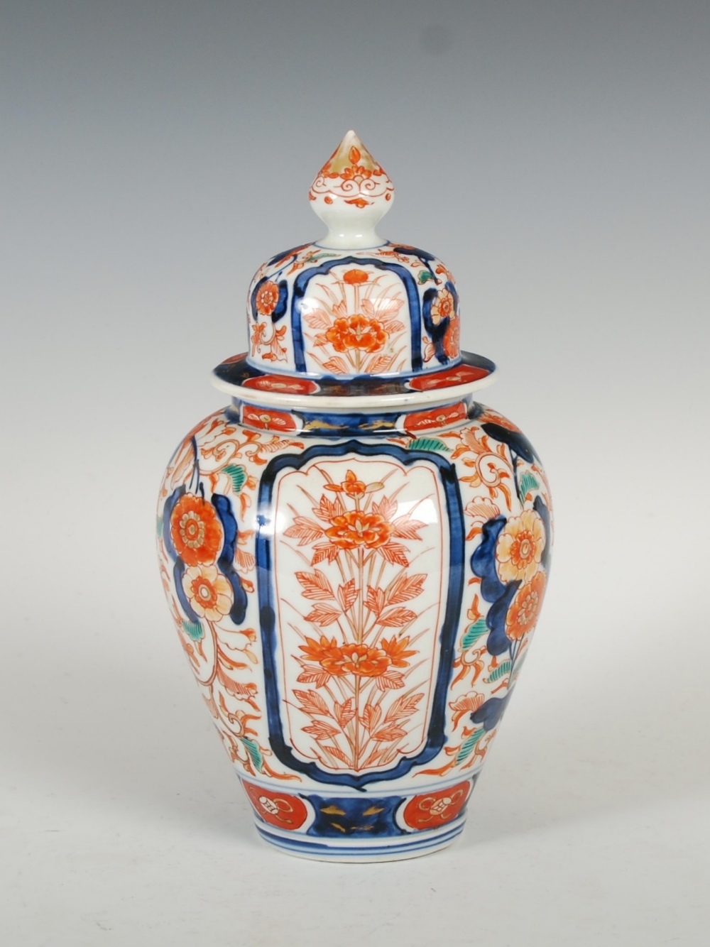 A late 19th/ early 20th century Japanese Imari jar and cover, decorated with two rectangular